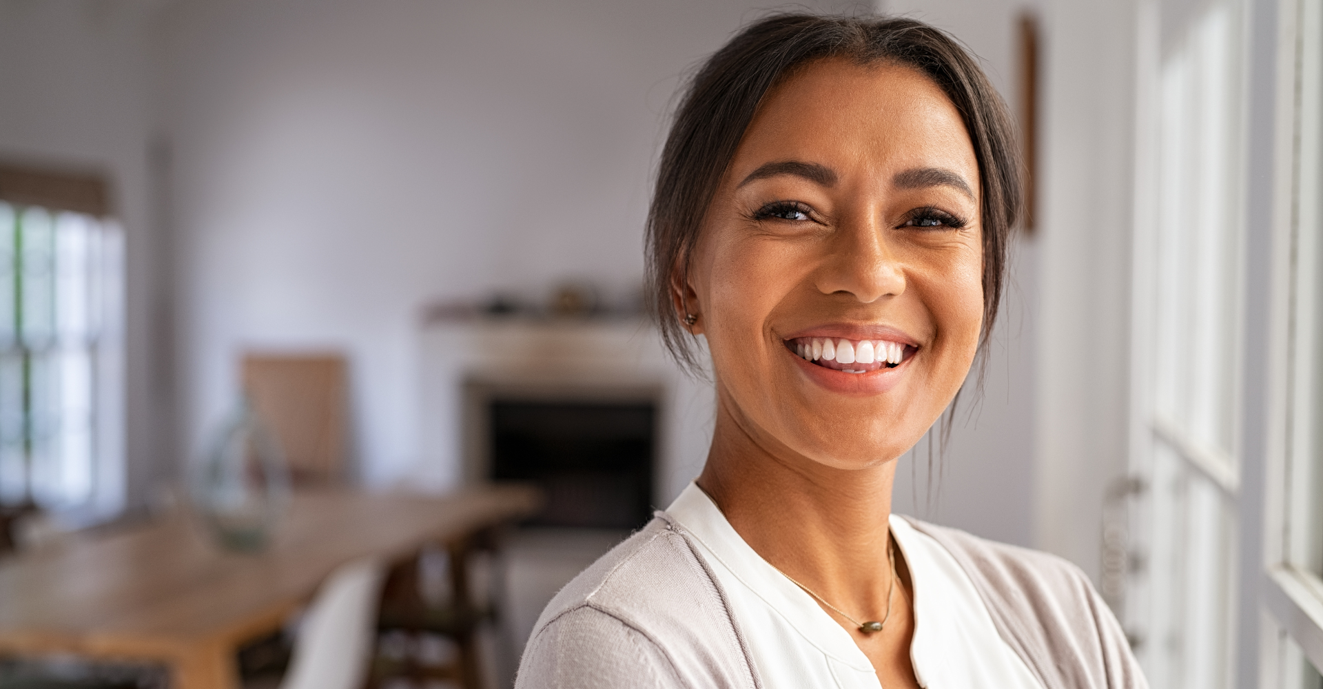 portrait of a beautfiful african woman smiling confidently after bulkamid treatment by Dr. Gaul in Millcreek, Utah Phase 2 Women